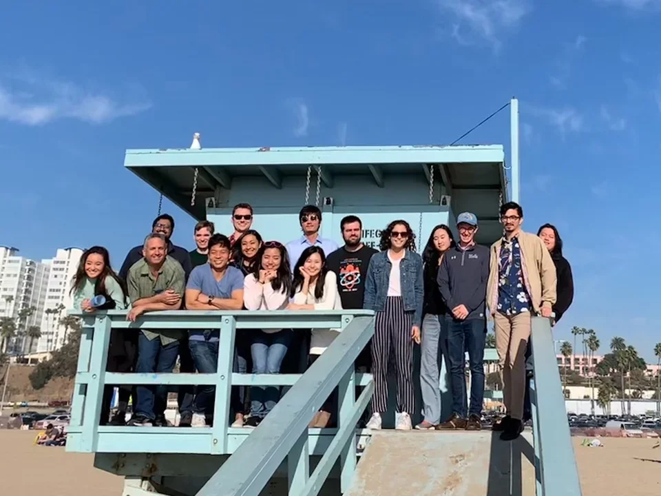 Teitell group photo standing on a lifeguard tower on Santa Monica Beach