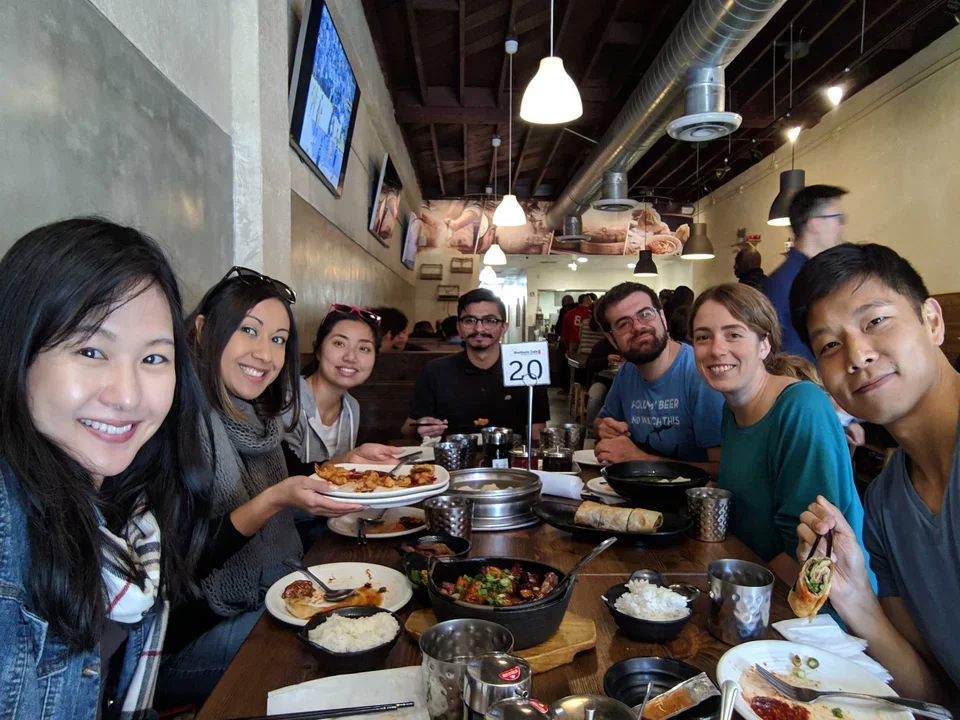 Teitell lab members sit around a table at China Northern cafe. They're all eating and smiling