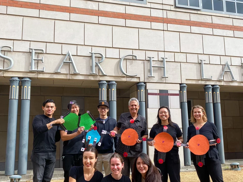 Teitell lab members wear a group costume for Halloween. They're dressed up as a collective ATP molecule 