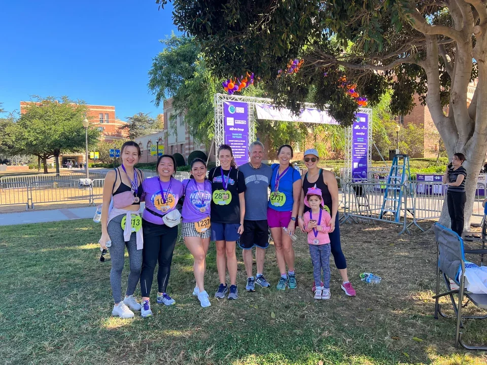 Teitell lab members stand together outside on the grass after running in a 5k for the Hirschberg Foundation for Pancreatic Research