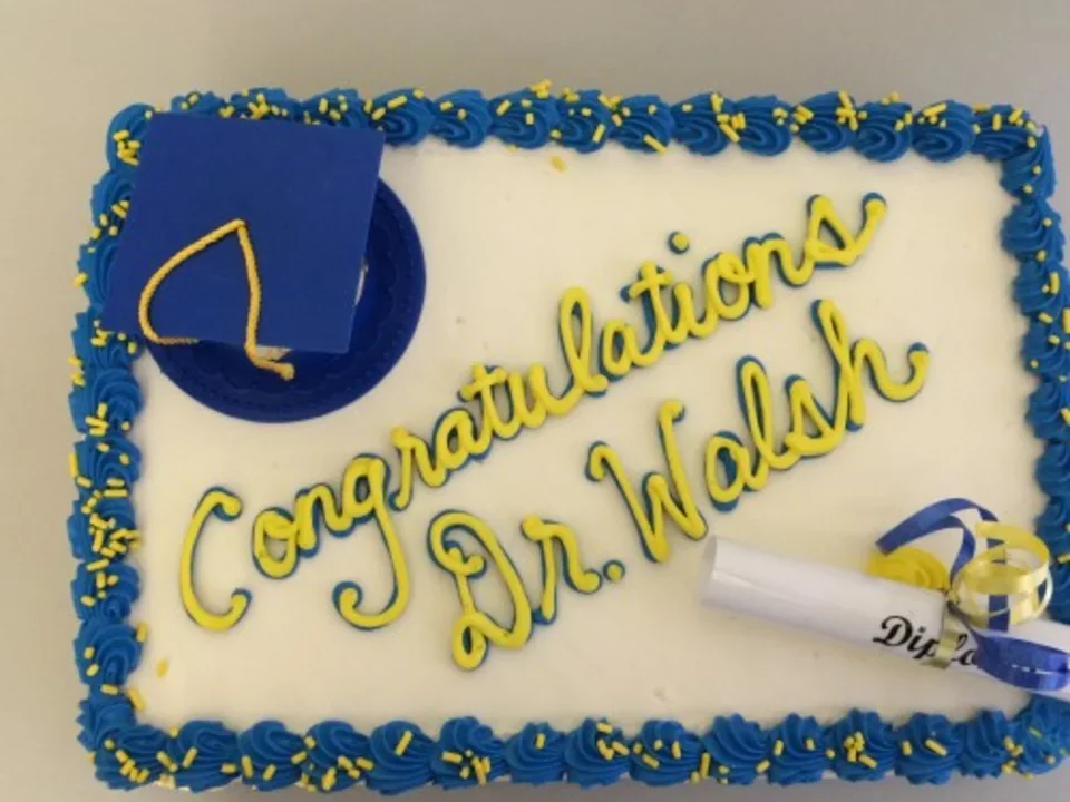A cake that reads "Congratulations, Dr. Walsh" 