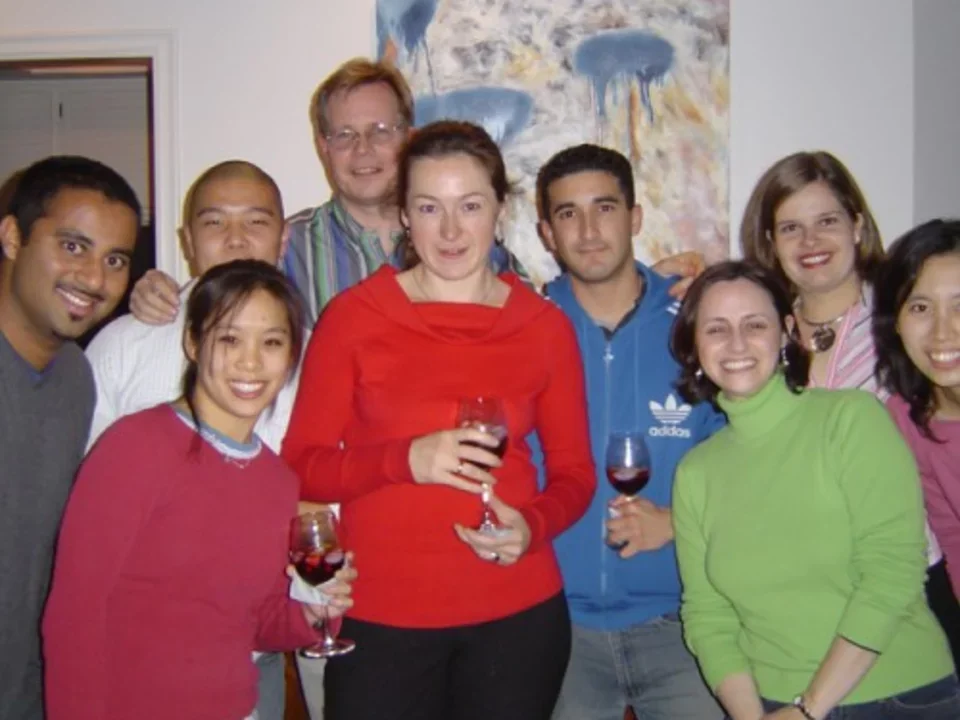 2005 Teitell lab members holding glasses of wine group together