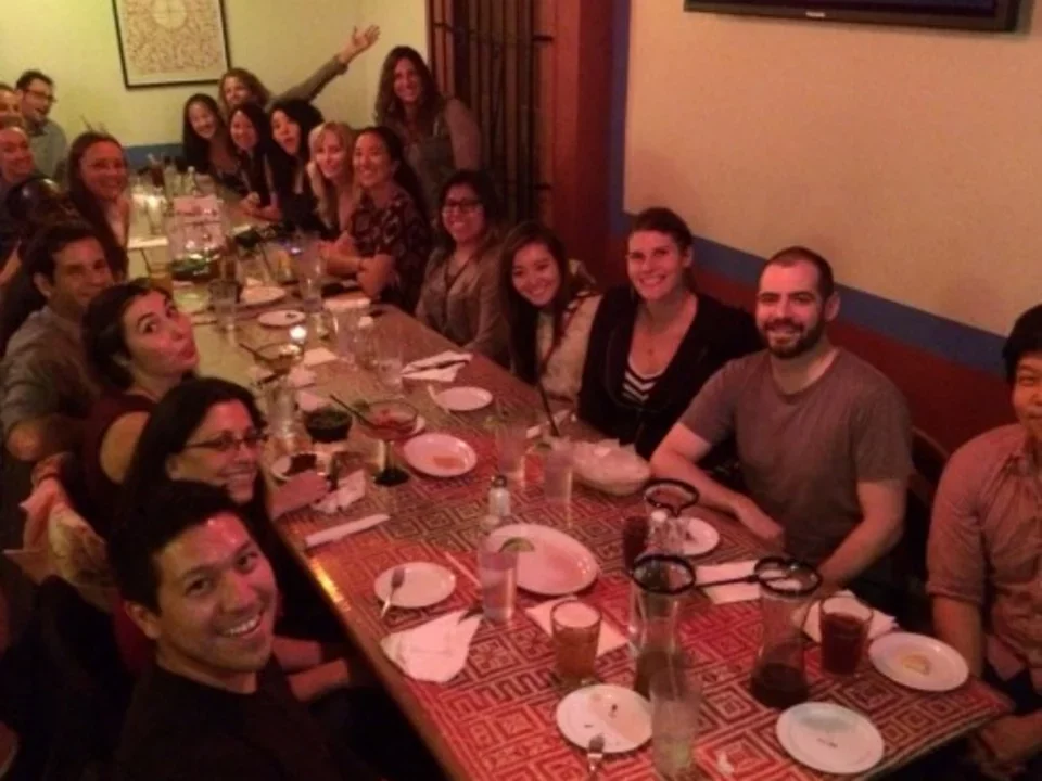 Teitell lab celebrates a birthday at a long table at a restaurant 