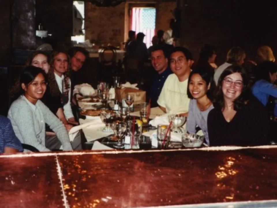Teitell lab sits at a restaurant table in 2001 for a holiday celebration